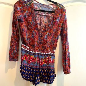 Small multi color, flower embellished romper.